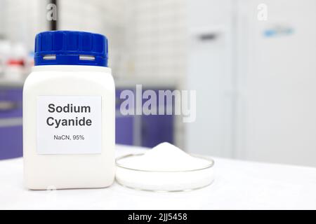 Selective focus of a bottle of Sodium Cyanide pure chemical compound used for cyanide fishing. White laboratory background. Stock Photo