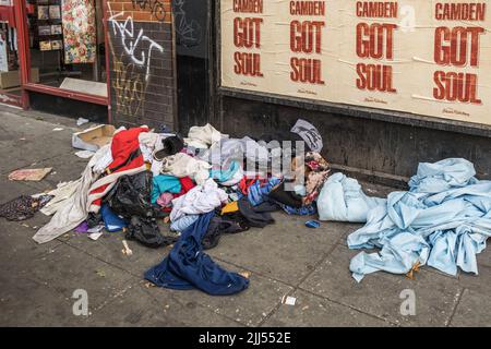 Old Dirty Clothes left discarded on a high street in Camden, North London, England, UK. Stock Photo