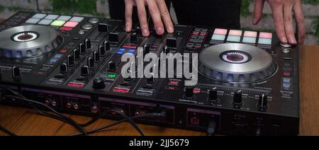 DJ Music night club, event, party. DJ Hands creating and regulating music on dj console mixer Stock Photo