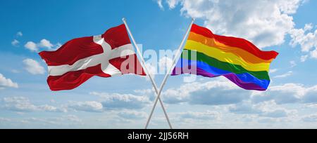 two crossed flags LGBT Pride and Malaysia waving in wind at cloudy sky ...