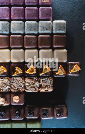 set of handmade chocolate candies with nuts, raisin, peanuts and hazelnut Stock Photo