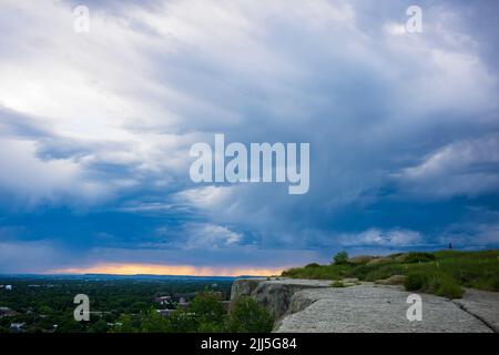 A thunderstorm moves across the horizon seen from Swords Park that overlooks the city of Billings, Montana. Stock Photo