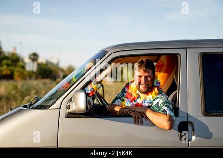 Smiling man looking through car window Stock Photo
