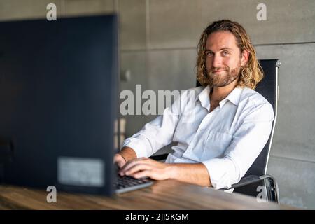 Businessman working on computer at desk in office Stock Photo