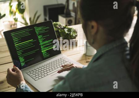 Freelancer coding on laptop working at home Stock Photo