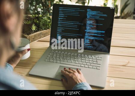 Freelancer computer programmer working on laptop at home Stock Photo