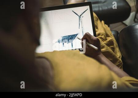 Engineer designing solar panel on graphics tablet at home office Stock Photo
