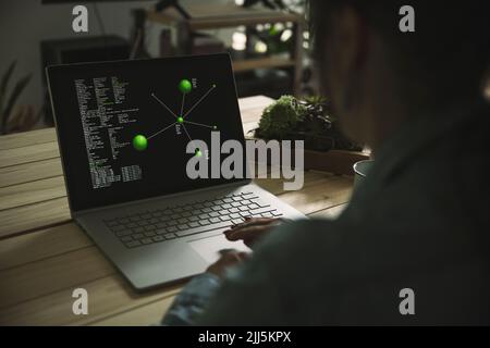 Freelancer using laptop on table at home office Stock Photo