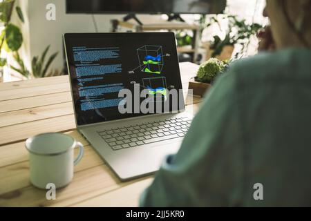 Freelance programmer with laptop and coffee cup at home office Stock Photo