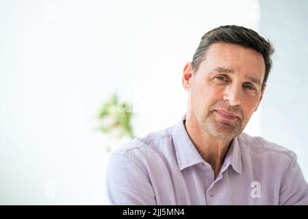 Mature businessman smiling at office Stock Photo