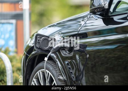 A black car with charging plug Stock Photo