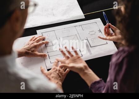 Business colleagues discussing over floor plan on table at office Stock Photo