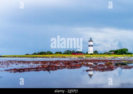 Sweden, Halland, Falkenberg, Cloudy sky over lighthouse in Morups Tange reserve Stock Photo