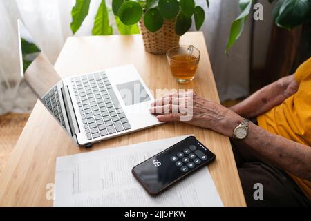 Senior woman using laptop at home Stock Photo