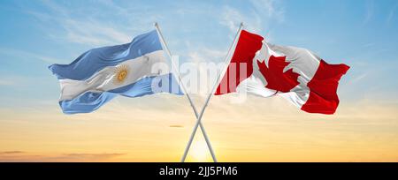 crossed national flags of Canada and Argentina flag waving in the wind ...