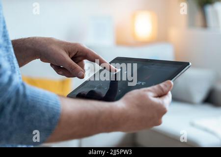 Hands of mature man using tablet PC in smart home Stock Photo