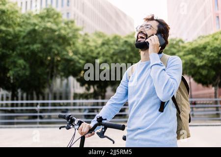Happy bearded man talking on mobile phone Stock Photo