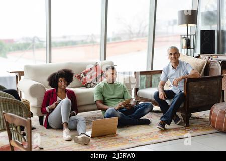 Happy business colleagues sitting together in office Stock Photo