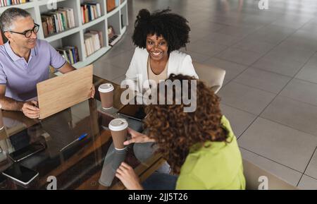 Happy business colleagues sitting together in office Stock Photo