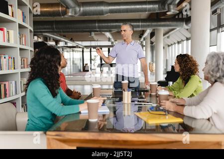 Businessman having meeting with coworkers at office Stock Photo