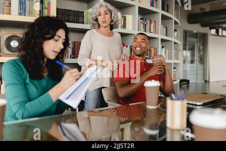 Senior businesswoman having meeting with colleagues Stock Photo