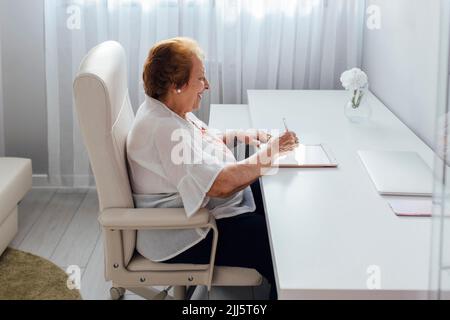 Happy woman using tablet PC at home Stock Photo