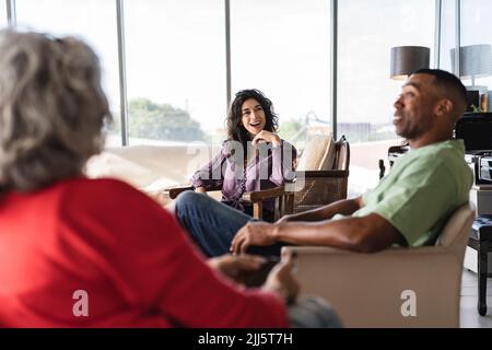 Happy business colleagues talking with each other in office Stock Photo