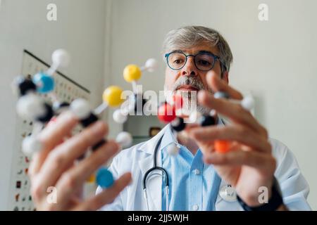 Scientist examining DNA molecule in laboratory Stock Photo