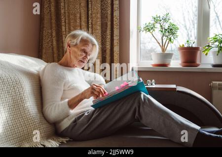 Senior woman reading documents at home Stock Photo