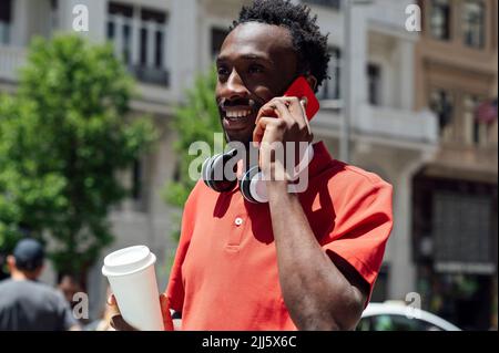 Man with coffee cup talking on phone Stock Photo