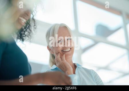 Happy businesswoman with colleague in office Stock Photo
