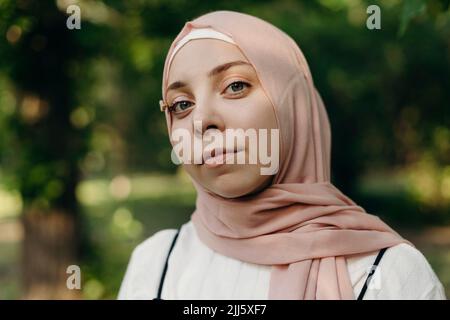 Young woman with hijab in public park Stock Photo