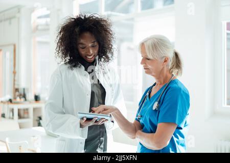 Two female doctors sharing tablet PC Stock Photo