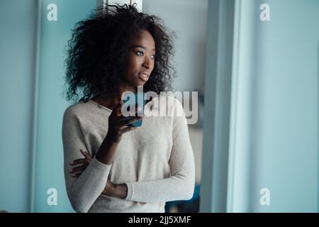 Young woman holding smart phone Stock Photo