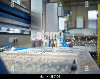 CNC machine cutting wood in factory Stock Photo