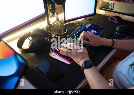 Man typing on keyboard sitting in front of desktop PC Stock Photo
