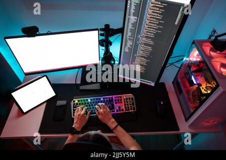 Computer programmer working on desktop PC at home Stock Photo