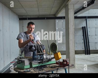 Mature plumber working at construction site Stock Photo