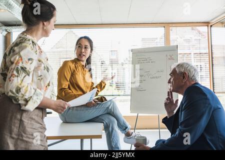 Business colleagues discussing work in office Stock Photo