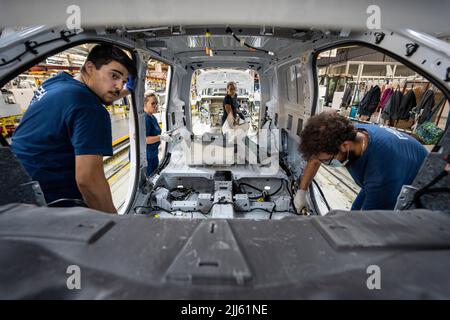 Workers at car factory assembly line Stock Photo