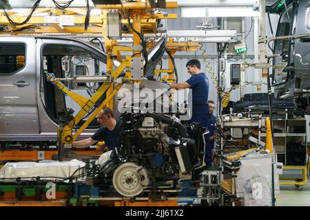 Workers at car factory assembly line Stock Photo