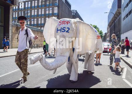 London, England, UK. 23rd July, 2022. Activists dressed as a white elephant march against the HS2 (High Speed 2) railway line. Protesters from Just Stop Oil, Extinction Rebellion, Insulate Britain and other groups staged a march through central London calling on the government to end fossil fuels, tax big polluters and billionaires, provide insulation for all homes, and act on the climate and cost of living crises. (Credit Image: © Vuk Valcic/ZUMA Press Wire) Stock Photo