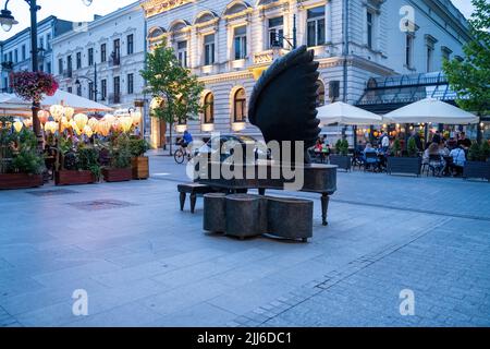 Lodz, Poland - July 08, 2022: THE RUBINSTEIN piano monument in PIOTRKOWSKA street in the city center during night Stock Photo