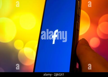 Turkey - April 2022: Facebook logo on the smartphone screen in hand. Facebook is a social networking service, owned and operated by Facebook.Inc. Stock Photo