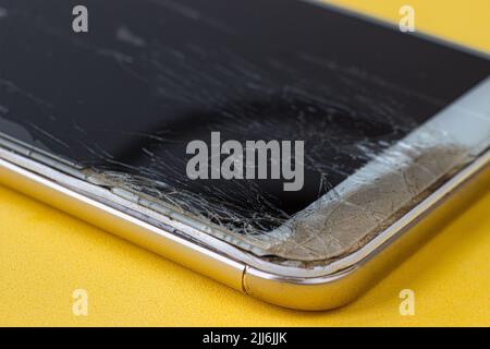 A closeup shot of a cracked broken old smartphone Stock Photo