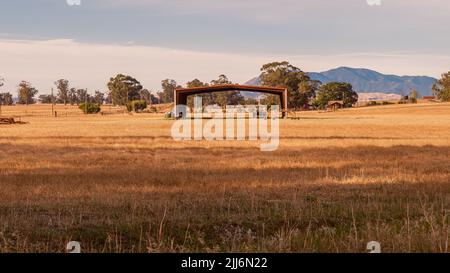 Shed and tractor in agricultural field with Mt Diablo in background Stock Photo