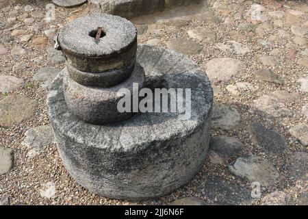 Old ancient stone mill. Millstones for grinding wheat or other grains, grinding stones. Stock Photo