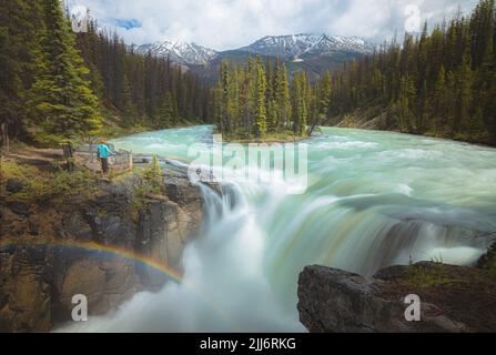 Epic scenic landscape view of Sunwapta Falls waterfall and Athabasca Glacier at Jasper National Park in the Rocky Mountains of Alberta, Canada. Stock Photo