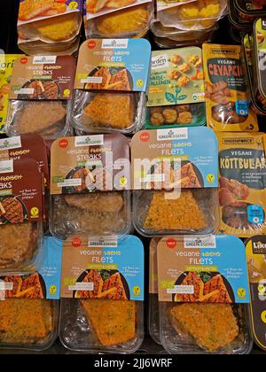 selection of vegan food packages made by different brands in a supermarket Stock Photo