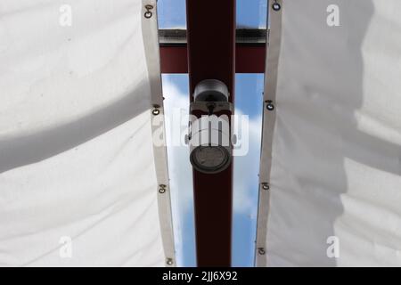 A projector fixed on the ceiling of a veranda Stock Photo